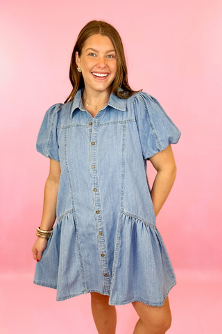 Lightwash denim dress with button down front, puff sleeves, and side pockets. Concert dress. summer dress. casaul dress.