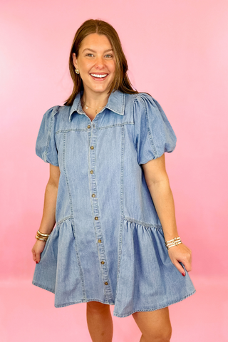 Lightwash denim dress with button down front, puff sleeves, and side pockets. Concert dress. summer dress. casaul dress.