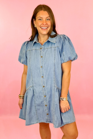 Lightwash denim dress with button down front, puff sleeves, and side pockets. Concert dress. summer dress. casaul dress.