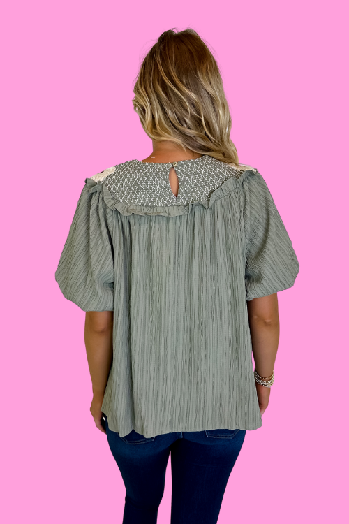 Olive green blouse with smocked neckline