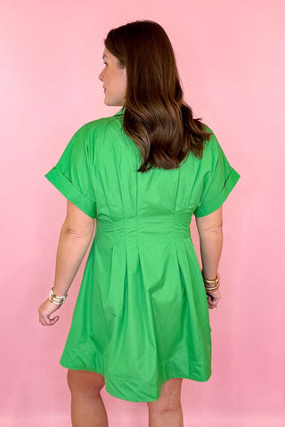 Green button down dress with cinched waist and pleated detailing