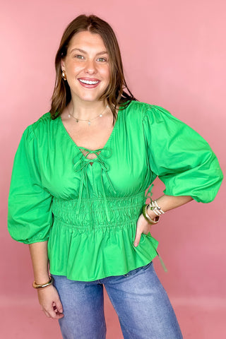 green peplum tie front top with a smocked waist 