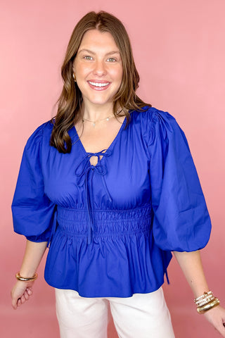 royal blue peplum tie front top with a smocked waist 