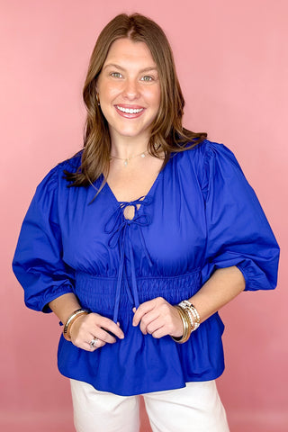 royal blue peplum tie front top with a smocked waist 