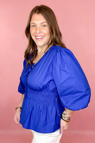 royal blue peplum tie front top with a smocked waist 