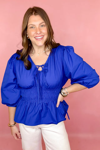 royal blue peplum tie front top with a smocked waist 