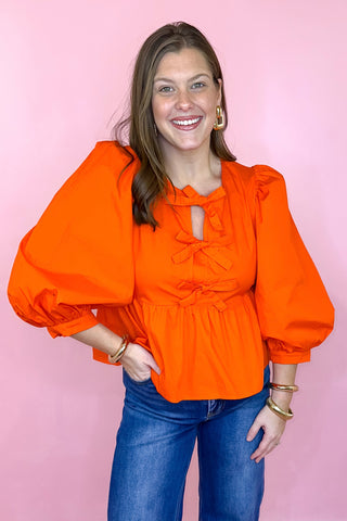 Orange Peplum Bow Top