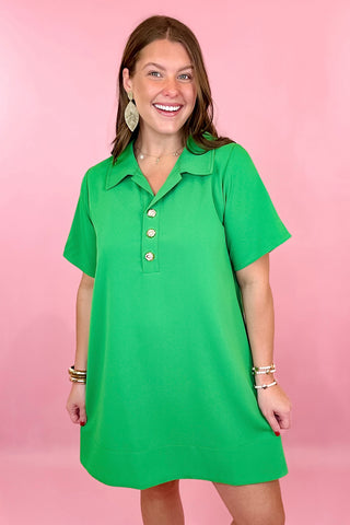 relaxed fit dress is green with short sleeves, fold over collar, gold button detailing on the chest, and side pockets. summer dress.easter dress. beach dress