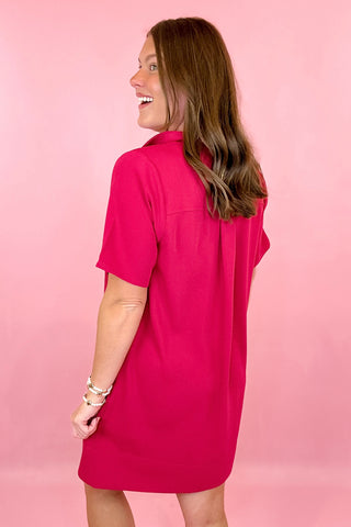 relaxed fit dress is pink with short sleeves, fold over collar, gold button detailing on the chest, and side pockets. summer dress.easter dress. beach dress