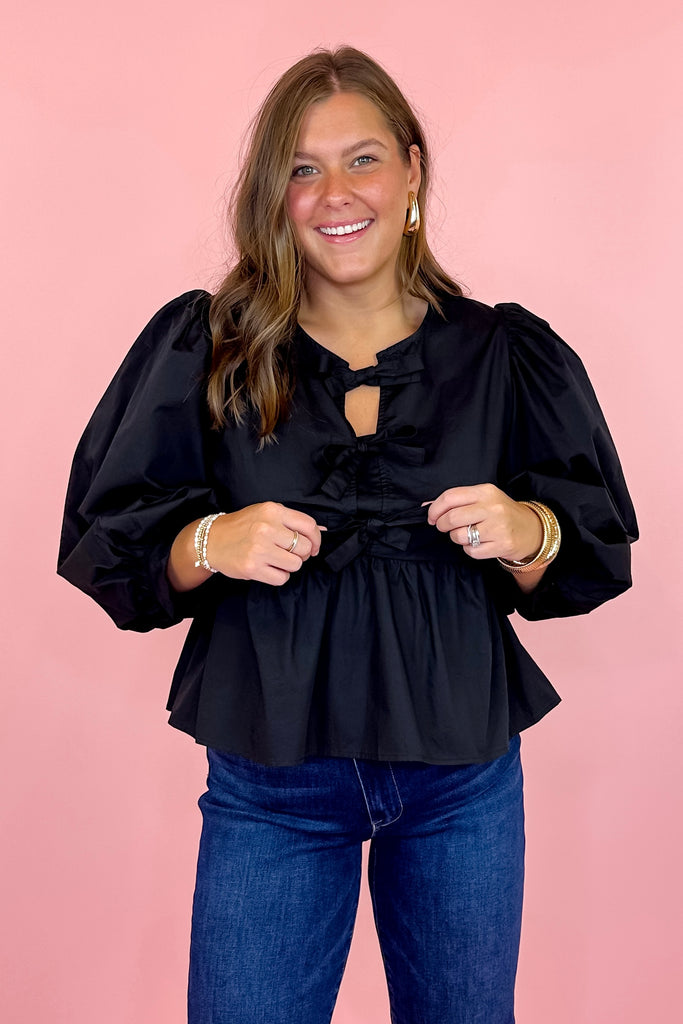 peplum top with bow detailing