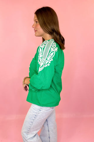 green top with white embroidery