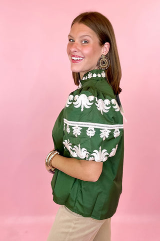 green embroidered top